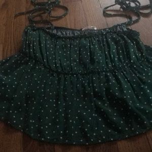 Green tank with white polka dots
